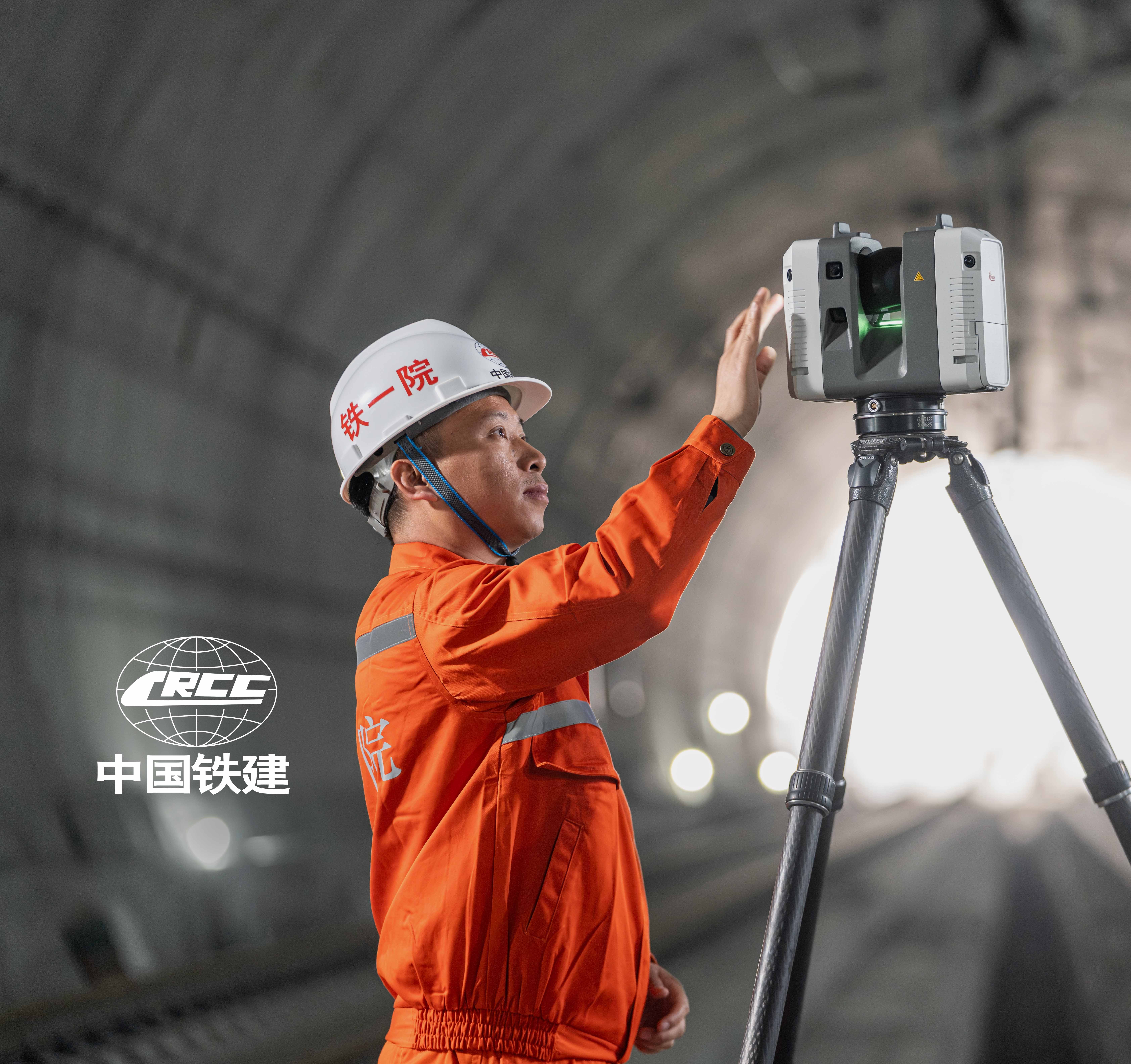 A construction worker wearing protective gear operates a surveying instrument outdoors.